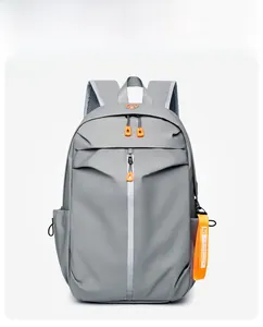 Close-up of waterproof grey backpack featuring orange zipper accents and mesh straps
