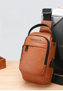 Brown leather sling bag detail with side USB charging port and textured finish