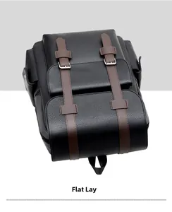 Detailed macro view of the pebble-grain leather texture and metallic buckle on the backpack