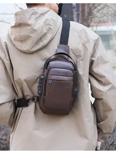 Detail of brown leather chest bag showing anti-theft combination lock and USB charging port
