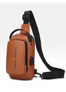 Detail view of the brown leather chest bag featuring a built-in USB charging port