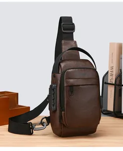 Detail view of brown leather sling bag featuring an integrated anti-theft combination lock
