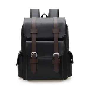 Vintage black leather backpack with brown straps and silver buckles on white background