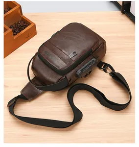Detail view of brown leather chest bag with anti-theft combination lock and USB port