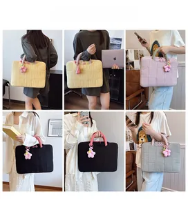 Λεπτομερής προβολή καπιτονέ τσαντών λάπτοπ σε διάφορα χρώματα με λούτρινα λουλούδια