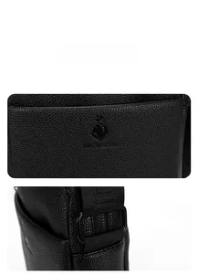 Detailed close-up of men's black lychee pattern leather bag with embossed shield logo