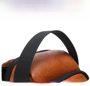 Detail view of the wide black handle and brown lychee textured leather on a men bag
