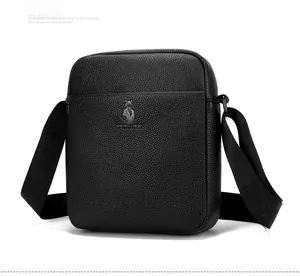 Side view detail of black lychee grain leather crossbody bag with metal logo