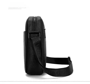 Side view of black lychee leather crossbody bag with dual metal zippers and wide strap