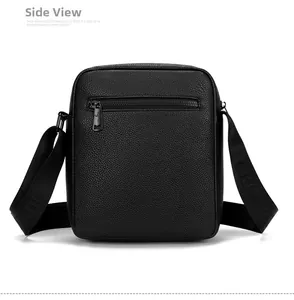 Rear view of black lychee grain leather crossbody bag showing functional back zipper pocket