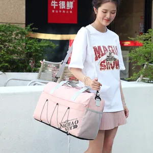 Pink waterproof nylon gym bag with gray straps and side mesh pocket for travel
