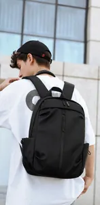 Lightweight black urban backpack on model featuring waterproof fabric and minimalist design