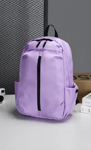 Detail view of purple nylon backpack showing dual zippers and vertical front pocket