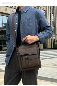 Detailed view of brown leather crossbody bag with adjustable strap and top handle