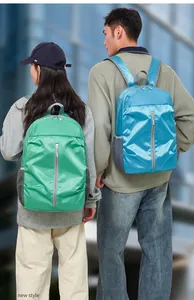 Detailed back view of casual blue and green backpacks with waterproof grid texture fabric