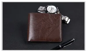 Macro shot of vintage brown leather wallet texture with business watch and pen