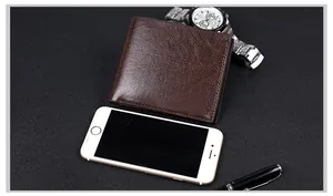 Business style dark brown leather wallet for men next to a smartphone and watch