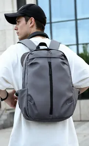 Urban grey commuter backpack featuring a waterproof nylon finish and vertical front zipper