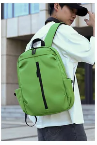 Detail of green waterproof backpack with vertical front zipper and reinforced black handle
