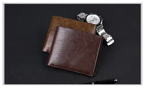 Classic men's short leather bifold wallet shown with business watch and pen