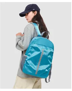 Detail view of a lightweight blue outdoor backpack with mesh side pocket and zipper