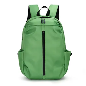 Front view of grass green waterproof nylon backpack with black zippers for travel and school