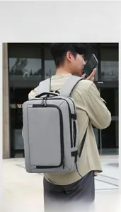 Detail of grey laptop backpack showing side USB charging port and sleek fabric texture