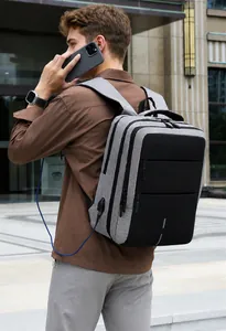 Detail of grey oxford backpack featuring external USB charging port and side pocket