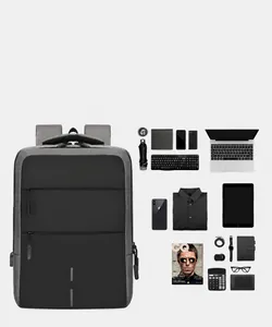 Flat lay of gray waterproof business backpack with laptop and multi-layer storage items