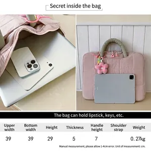 Pink quilted 16-inch laptop bag with green handles and large internal storage capacity