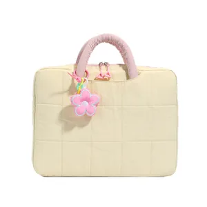 Quilted beige 16-inch laptop bag with pink handles and floral plush pendant decoration