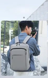 Detail of grey waterproof laptop backpack with side USB charging port and zipper pockets