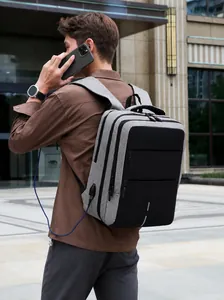 Detail of waterproof Oxford business backpack showing external USB charging port with cable