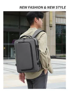 Side view of a dark grey business laptop backpack being worn in a modern outdoor setting