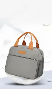 Vue détaillée du sac isotherme gris avec poignées orange et poche latérale en filet