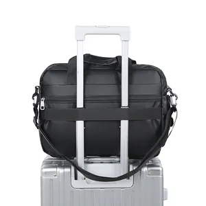 Black Oxford cloth briefcase attached to suitcase handle with adjustable shoulder strap