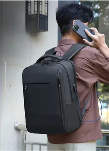Close-up of black business backpack featuring an external USB charging port and cable