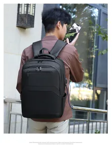 Detail of waterproof business backpack showing USB charging port and padded shoulder straps