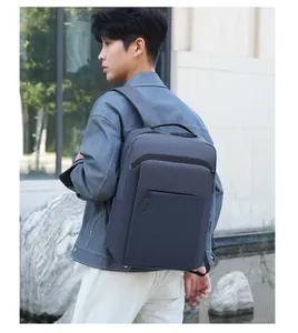Outdoor shot of a man wearing a waterproof 16-inch laptop backpack for business travel