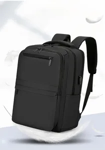 Detail of expandable black travel laptop backpack showing USB port and lightweight design