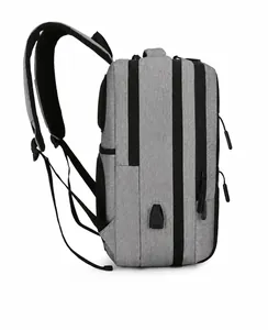 Detail of grey oxford laptop backpack showing the side USB charging port and zipper layers