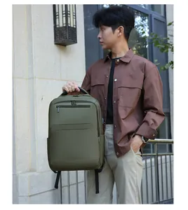 Olive green business laptop backpack detail with USB charging port and thick handle