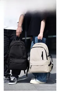 Detailed comparison of black and cream large waterproof backpacks for daily travel