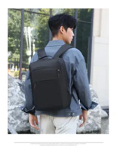 Detail view of a black 16-inch laptop backpack featuring a side USB charging port for men