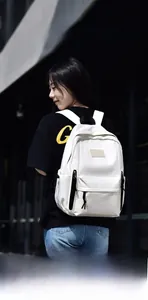 Photo lifestyle d'un sac à dos blanc minimaliste porté par un mannequin dans une rue urbaine