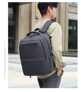 Detail view of charcoal gray expandable business backpack with USB port and padded handle