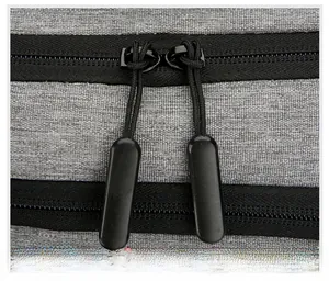 Close-up of durable double zipper pullers on a 16 inch grey laptop backpack