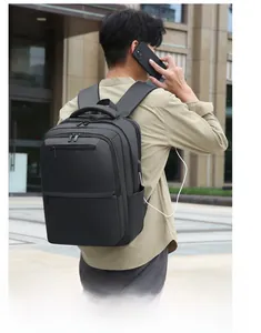 Men's expandable business backpack with USB charging port shown in a street scene