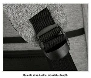 Close-up of adjustable shoulder strap buckle on a gray textured laptop backpack