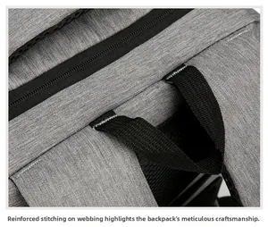 Detail of reinforced stitching on the black webbing handle of the grey travel backpack